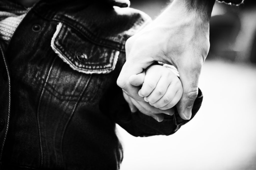 Blog Art - Black and white photo. Trust family hands of child son and father on nature outdoor